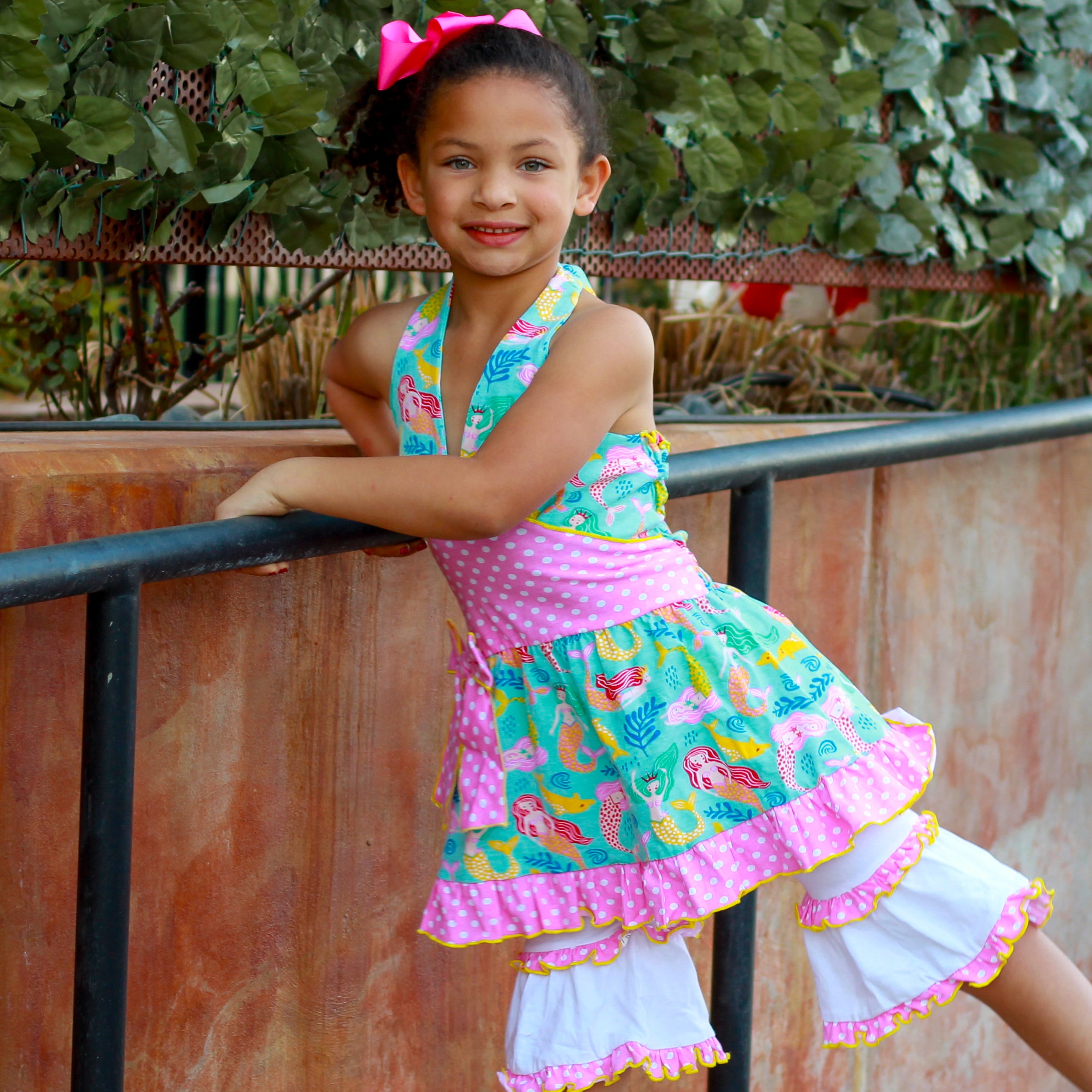 AnnLoren Girls Mermaid Halter Dress featuring a pink polka dot waistband and big bow, paired with white ruffle shorts, perfect for summer wear.